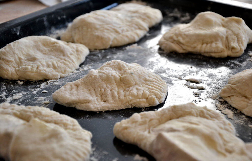Calzoni on a sheet pan, before baking.